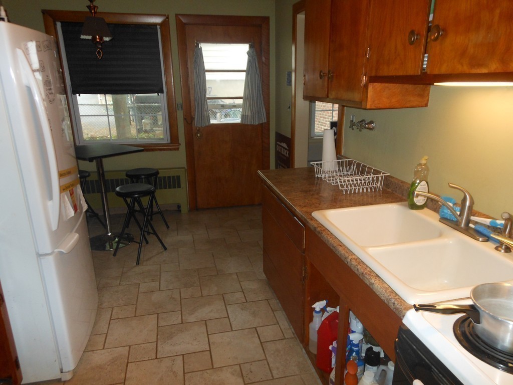 18 Pierce Street Malden, MA 02148 - Photo 22 of 29 a kitchen with a sink and cabinets