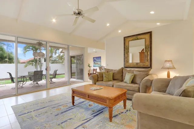 a living room with furniture a lamp and a table