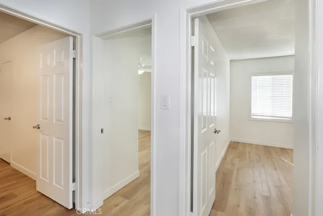 a kitchen with white cabinets and sink