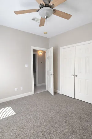 a view of an empty room with a ceiling fan