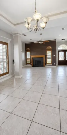 a view of an empty room with a fireplace and cabinet