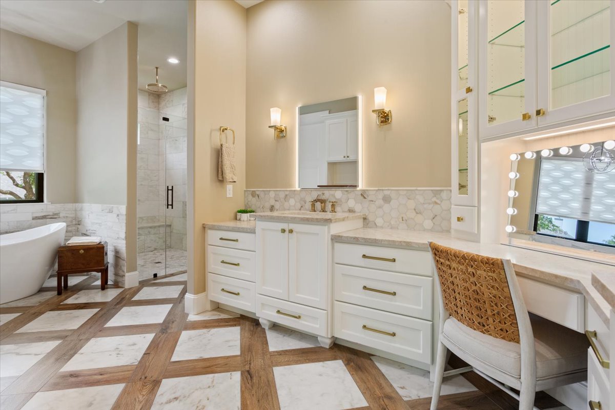 309 Highland Spring Lane Georgetown, TX 78633 - Photo 23 of 40 A distant view of the walk-in shower and freestanding soaking tub....