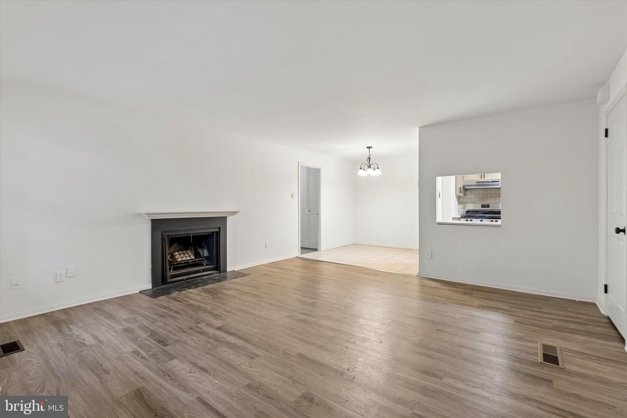 521 Old Forge Crossing Wayne, PA 19087 - Photo 2 of 15 a view of empty room with wooden floor and fireplace