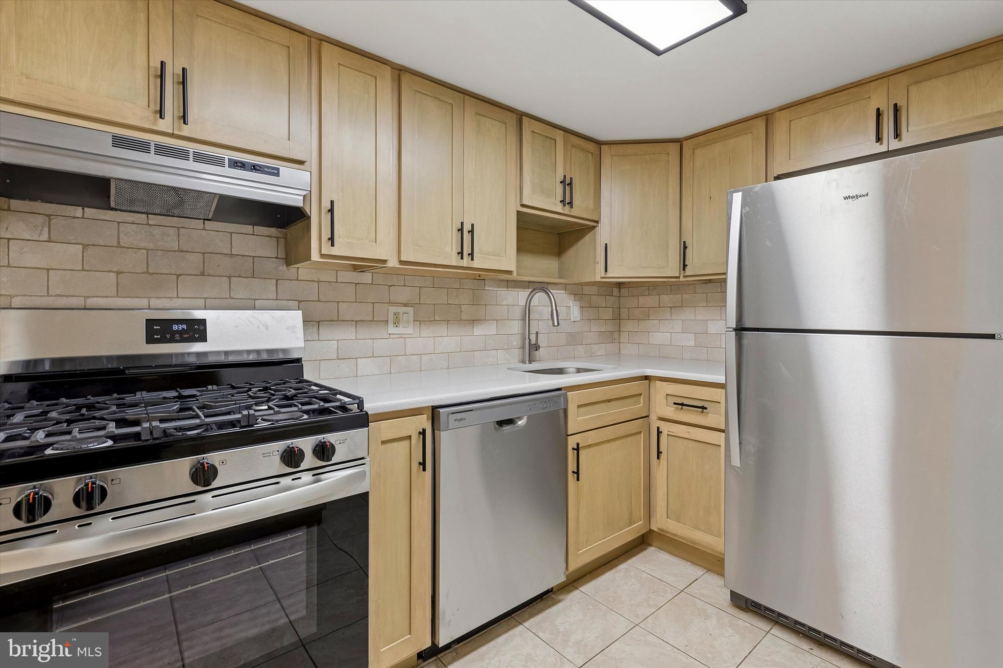 521 Old Forge Crossing Wayne, PA 19087 - Photo 7 of 15 a kitchen with stainless steel appliances granite countertop a refrigerator sink stove and cabinets