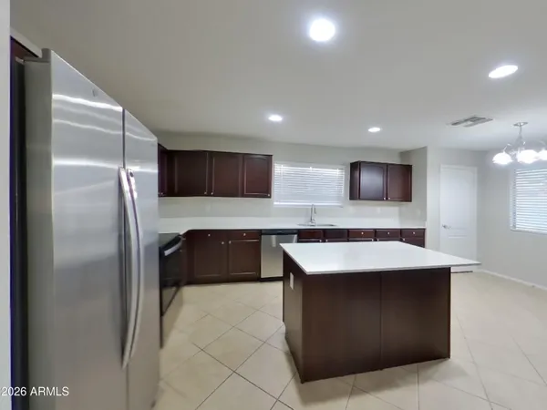 a kitchen with stainless steel appliances granite countertop a large counter top and a stove