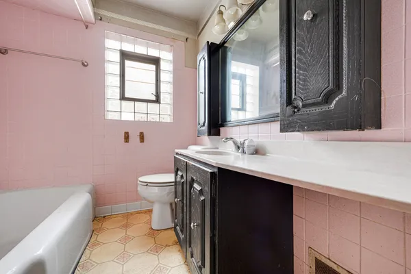 a bathroom with a sink a toilet and a mirror