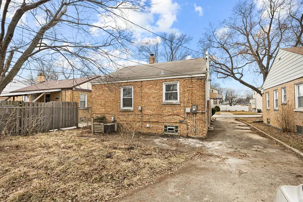 a white house that has a tree in front of it