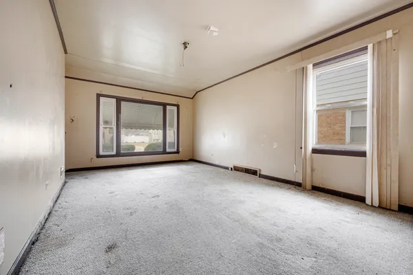 an empty room with windows and closet