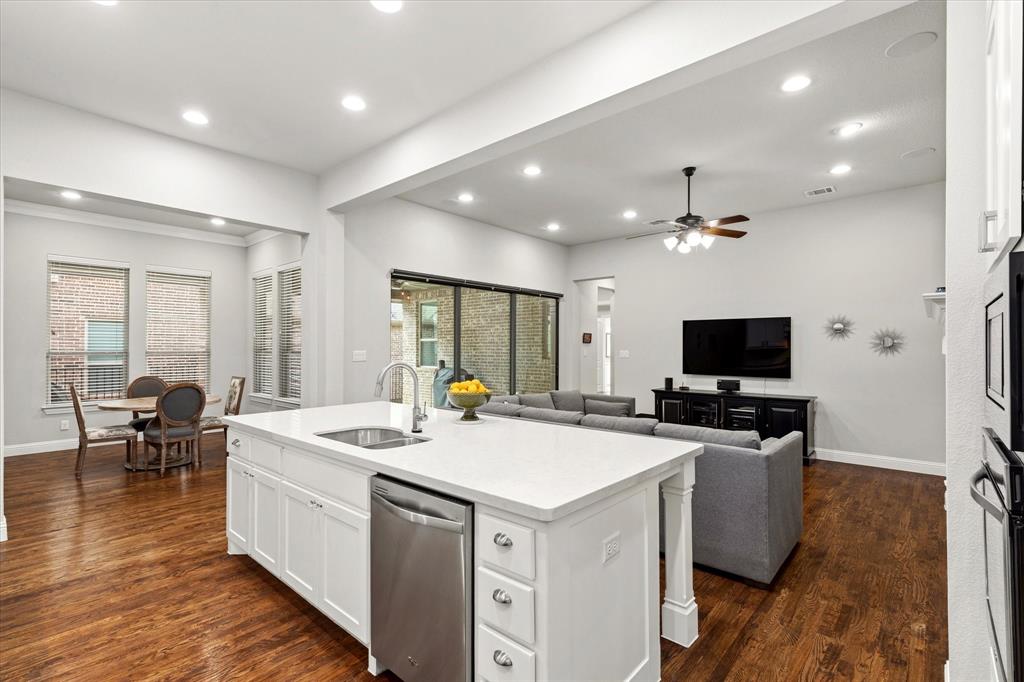 1108 Granada Drive Allen, TX 75013 - Photo 11 of 40 a kitchen that has a sink a stove and chairs