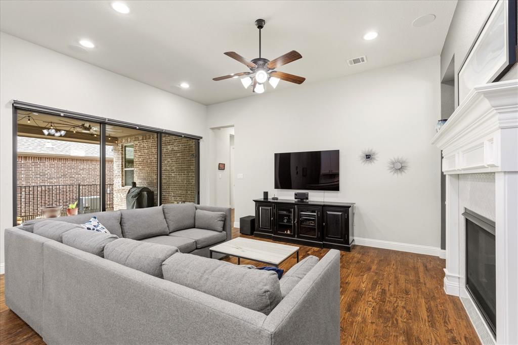 1108 Granada Drive Allen, TX 75013 - Photo 18 of 40 a living room with furniture and a flat screen tv