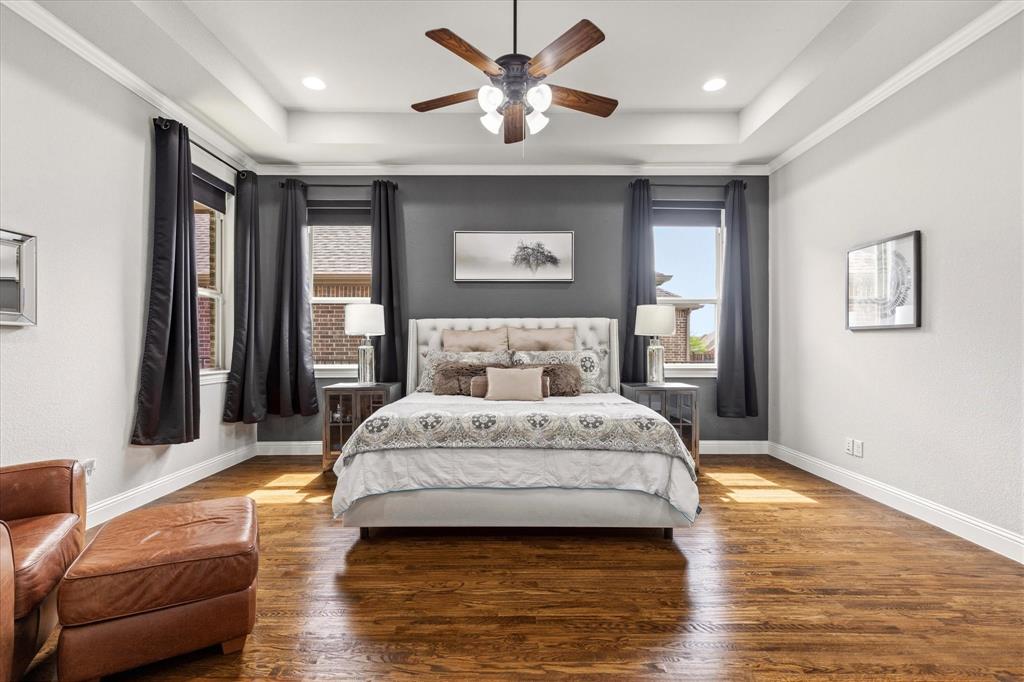 1108 Granada Drive Allen, TX 75013 - Photo 19 of 40 a spacious bedroom with a bed and a couch
