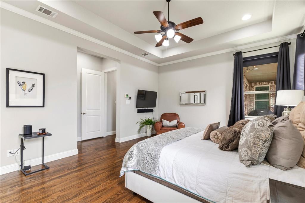 1108 Granada Drive Allen, TX 75013 - Photo 22 of 40 a bedroom with a bed and a chandelier