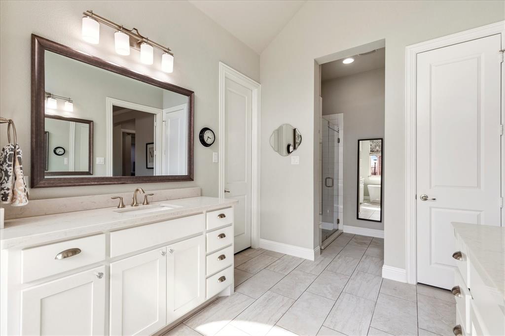 1108 Granada Drive Allen, TX 75013 - Photo 27 of 40 a spacious bathroom with a double vanity sink a mirror and a shower