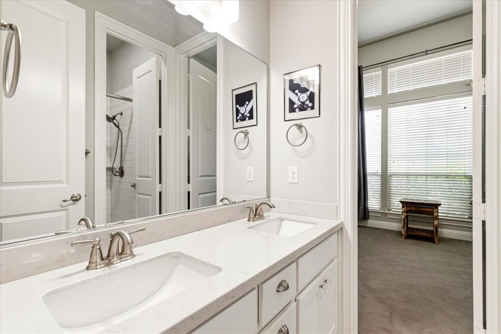 1108 Granada Drive Allen, TX 75013 - Photo 30 of 40 a en suite bathroom with a double vanity sink and a large mirror