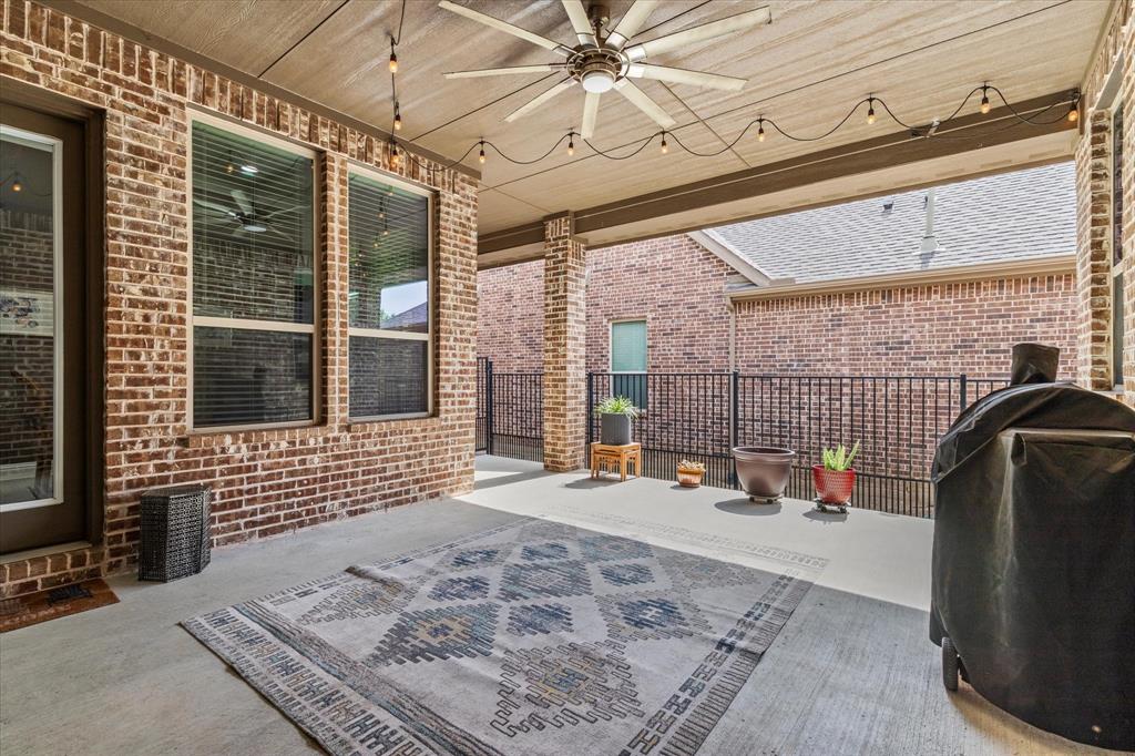 1108 Granada Drive Allen, TX 75013 - Photo 37 of 40 a view of a porch with a table and chairs