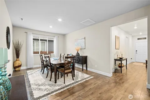 a view of a dining room with furniture and a window