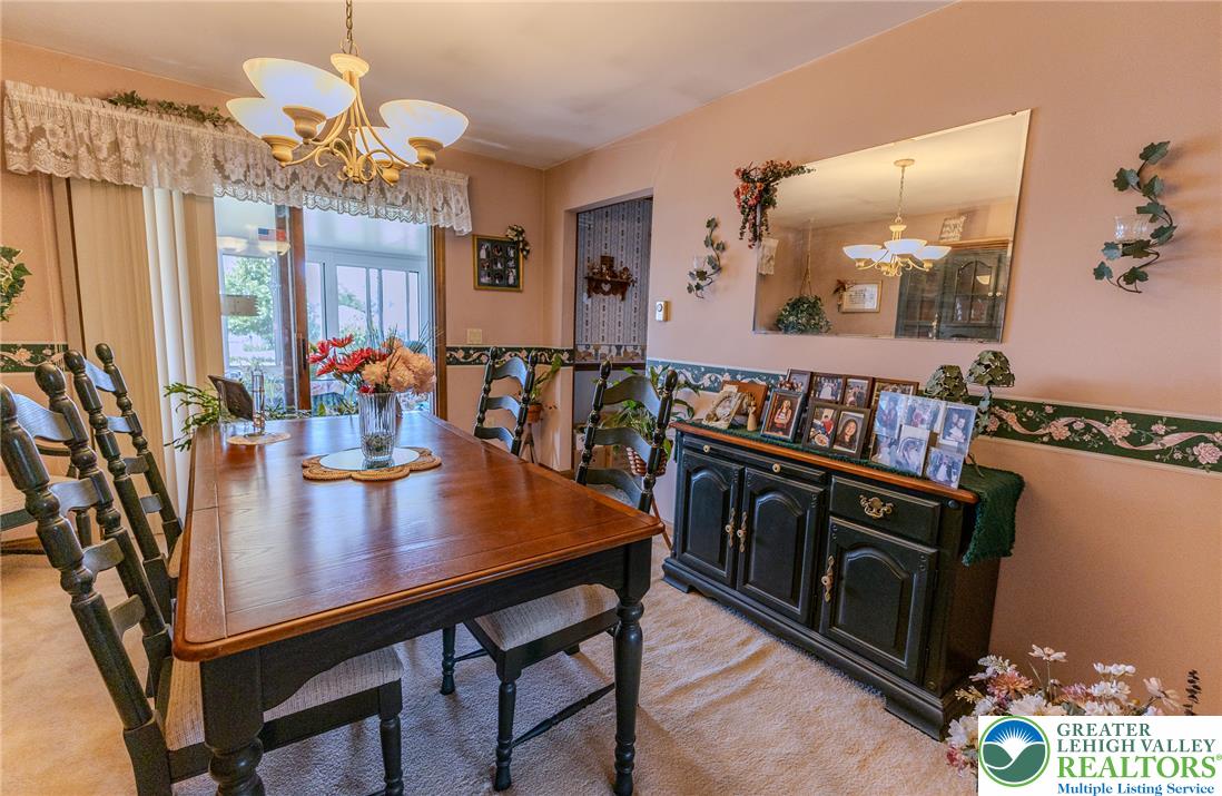 40 Locke Heights Road Bangor, PA 18013 - Photo 11 of 28 An inviting dining area, perfect for entertaining, with warm lighting and carpeted flooring.