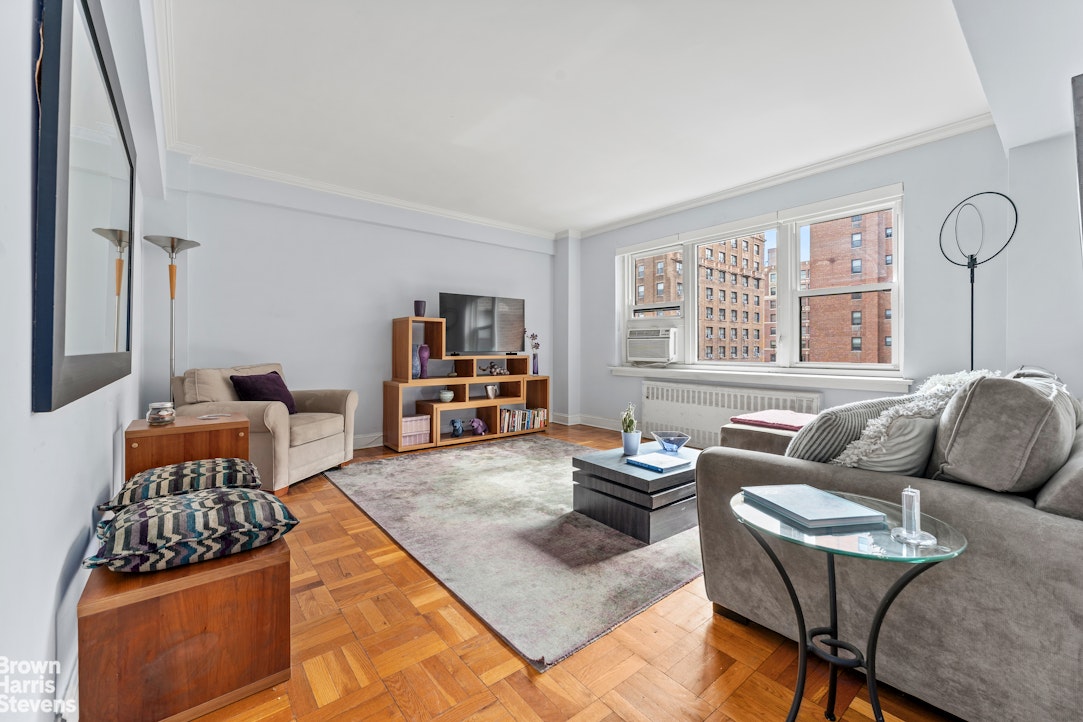 11 Riverside Drive, Unit 11AW Manhattan, NY 10023 - Photo 12 of 13 a living room with furniture fireplace and a window