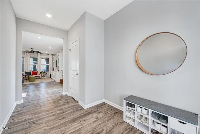 a dining room with furniture wooden floor a rug and a chandelier