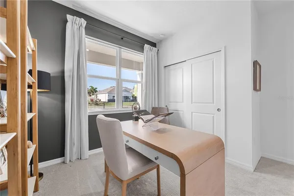 a dining room with stainless steel appliances granite countertop furniture and a window