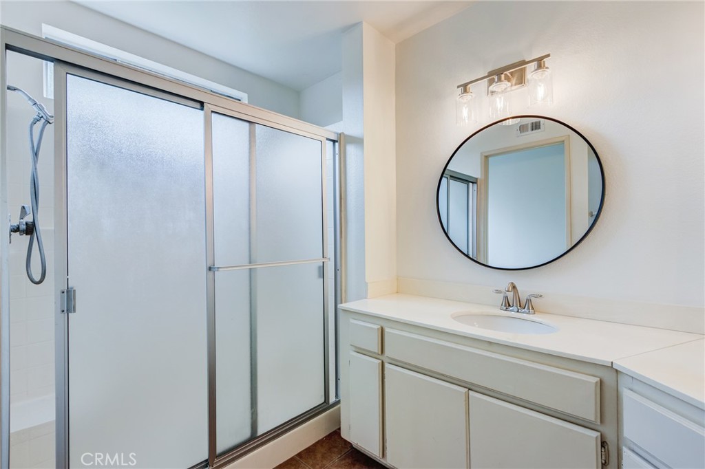 5349 Gooseberry Way Oceanside, CA 92057 - Photo 21 of 35 a bathroom with a sink a mirror a vanity and a shower