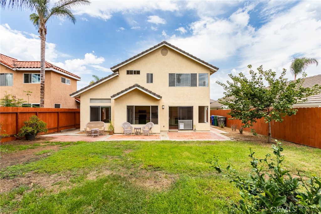 5349 Gooseberry Way Oceanside, CA 92057 - Photo 27 of 35 a large white house with a yard and sitting area