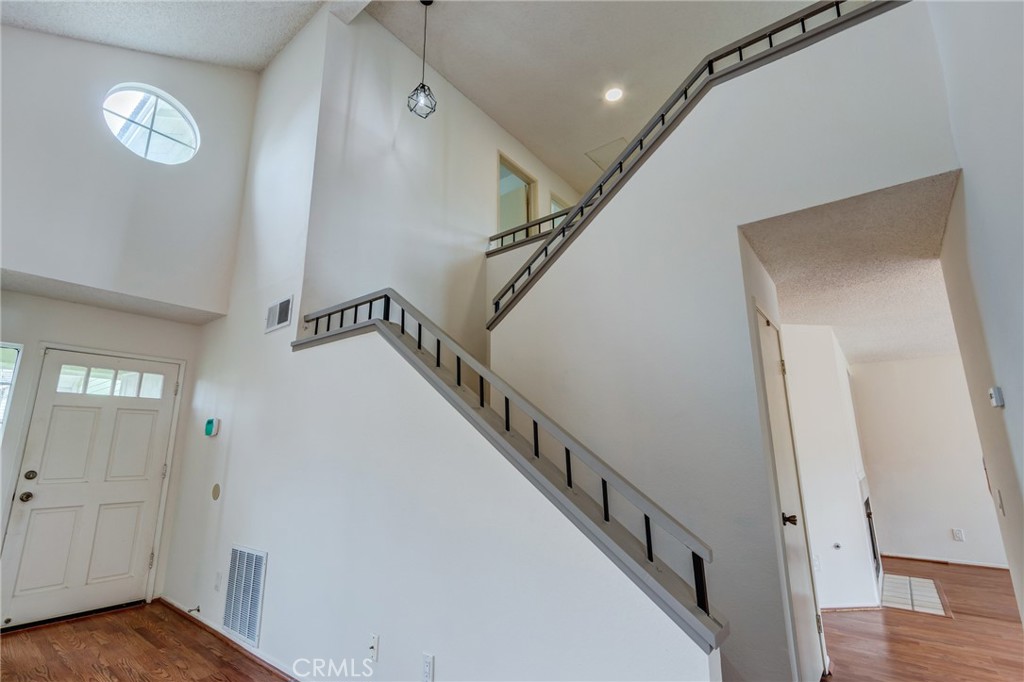 5349 Gooseberry Way Oceanside, CA 92057 - Photo 7 of 35 a view of a hallway with wooden floor and staircase