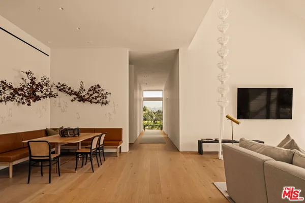 a view of a hallway with a view of a kitchen