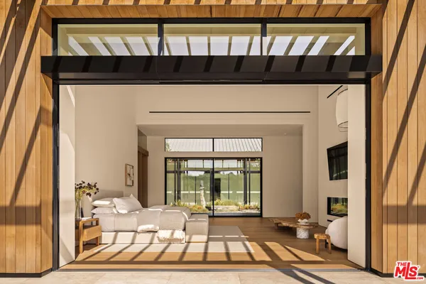 a bedroom with furniture and a flat screen tv