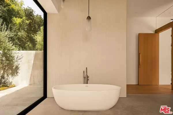 a bedroom with a large bed and a large window