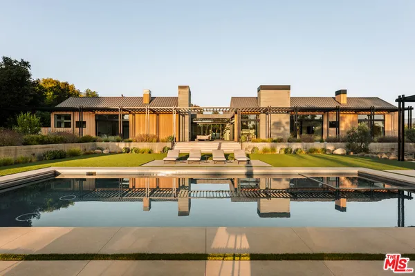 a view of a house with swimming pool and porch