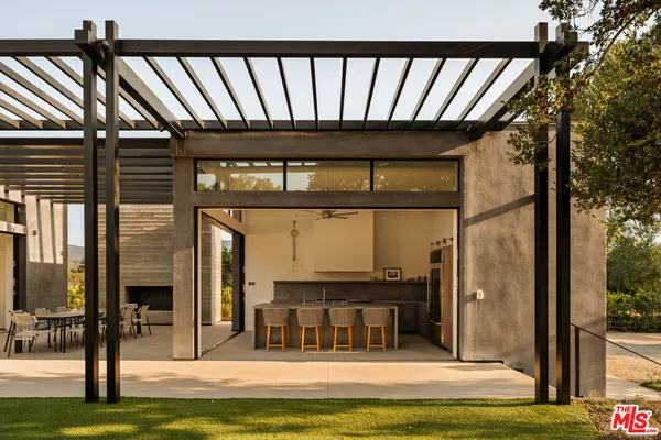 a building outdoor space with patio furniture and potted plants