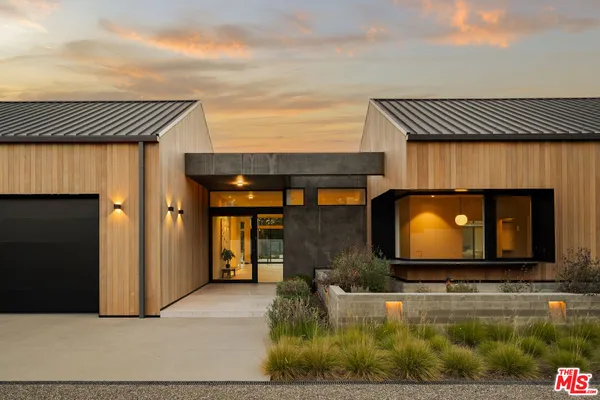 a view of backyard with large trees and wooden fence