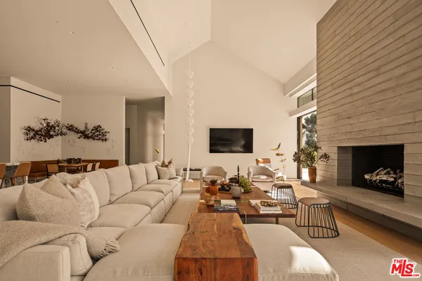 a view of a dining room with furniture and a floor to ceiling window