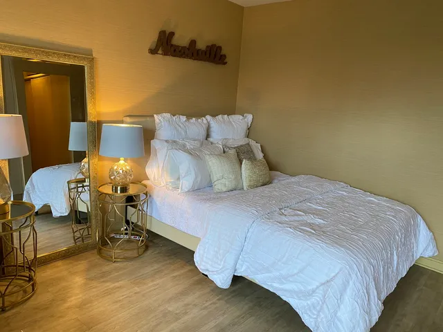 a bedroom with a bed and a mirror