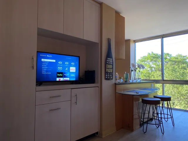 a kitchen with stainless steel appliances a sink and a large window