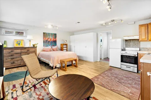 a bedroom with a bed and wooden floor