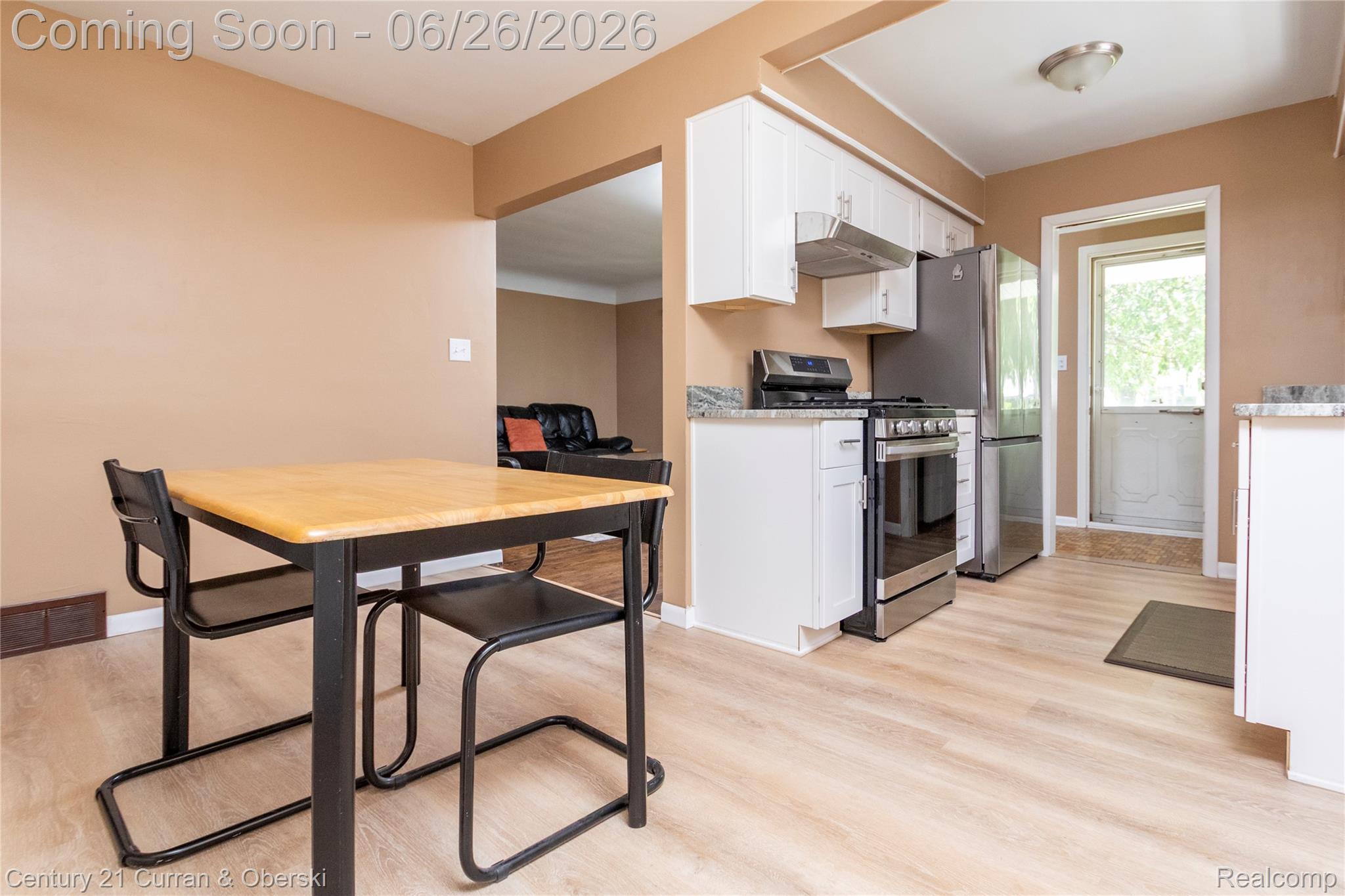3220 Alice Street Dearborn, MI 48124 - Photo 11 of 39 Kitchen featuring wood-finish flooring, white cabinetry, stainless steel appliances, and light-toned countertops