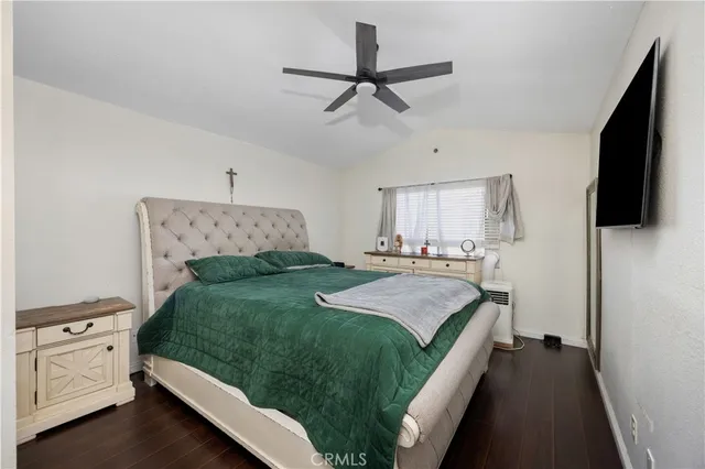 a spacious bedroom with a bed and a flat screen tv