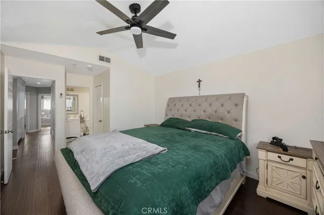 a bedroom with a bed and ceiling fan