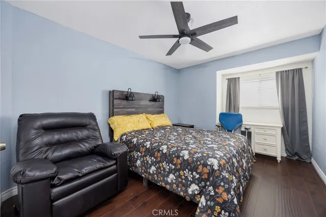 a bedroom with a bed couch and window