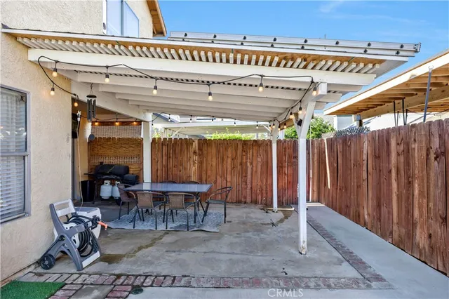 a view of a chairs and table in patio with wooden fence