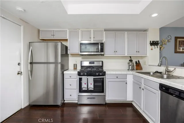 a kitchen with a refrigerator stove and sink