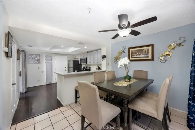 a view of a dining room with furniture and a chandelier