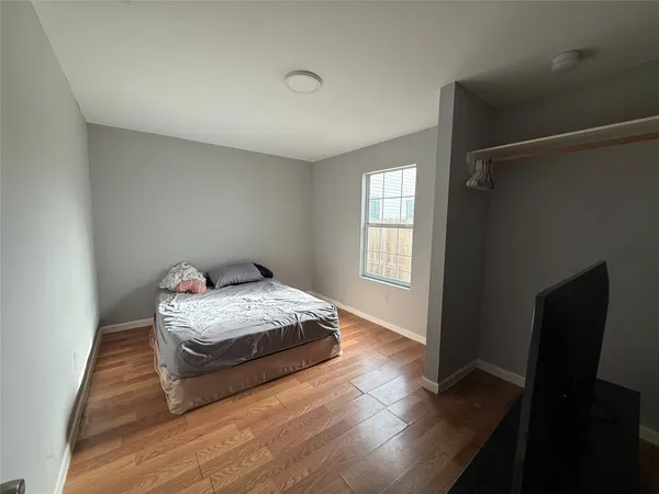 a bedroom with bed and window