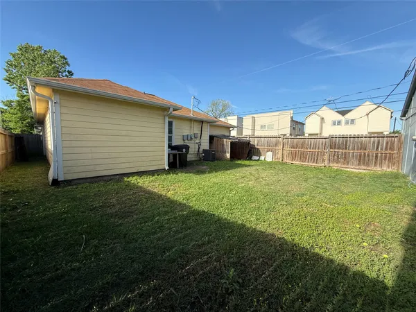 a view of a house with a yard and sitting area