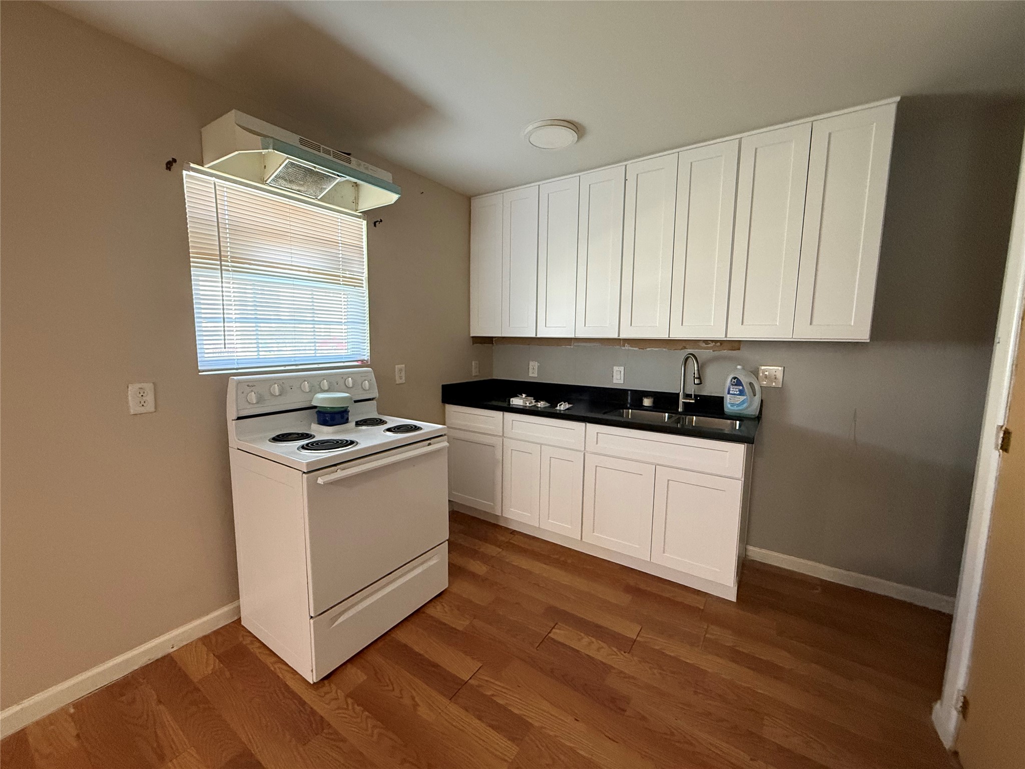 9307 Coffee Street Houston, TX 77033 - Photo 3 of 16 a view of kitchen with sink and wooden floor