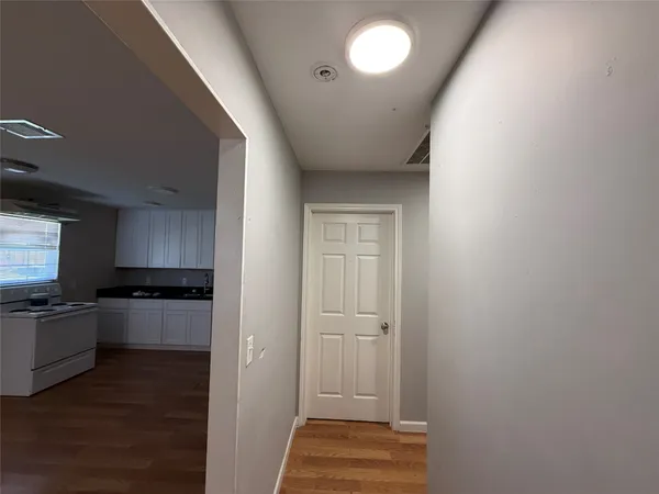 a kitchen with a refrigerator stove and wooden cabinets