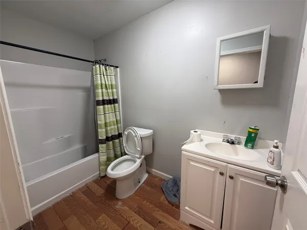 a white toilet sitting next to a bathroom sink