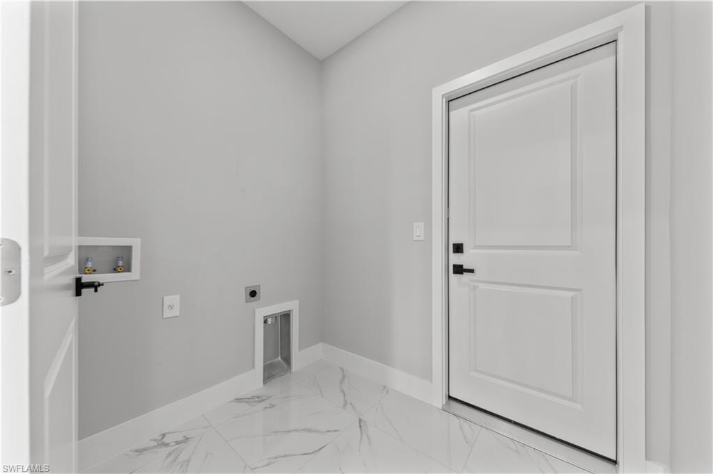 237 Columbus Boulevard South Lehigh Acres, FL 33974 - Photo 11 of 25 wooden floor and closet in a bathroom